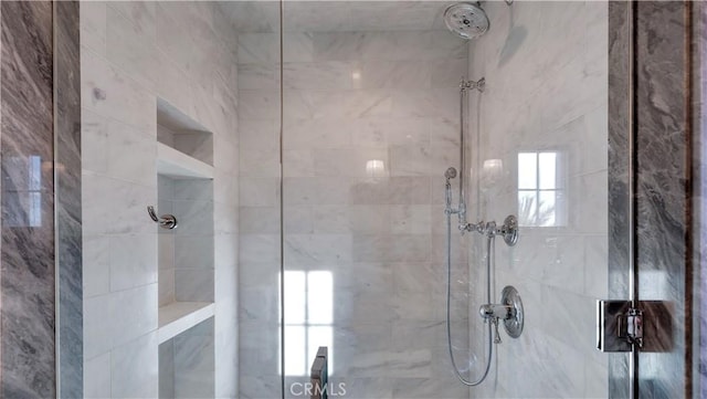 bathroom with tiled shower