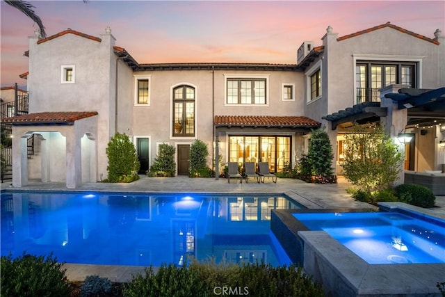 2 Thomas Rd, Ladera Ranch, CA 92694 - back of house at dusk featuring stucco siding, a pergola, a patio, and french doors