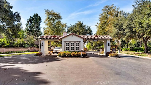 2 Thomas Rd, Ladera Ranch, CA 92694 - view of asphalt road featuring curbs and a gated entry