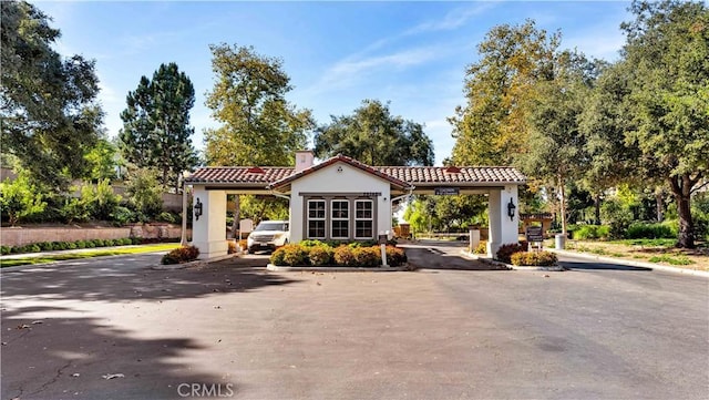 2 Thomas Rd, Ladera Ranch, CA 92694 - view of asphalt road featuring curbs and a gated entry