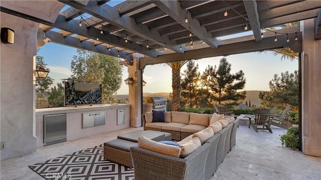 patio terrace at dusk with area for grilling, an outdoor living space, a pergola, and a grill