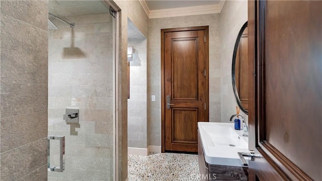 bathroom with crown molding, vanity, and walk in shower