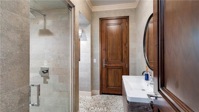full bath with vanity, crown molding, and a stall shower
