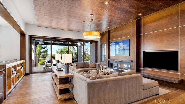 living room featuring light hardwood / wood-style floors and wooden ceiling