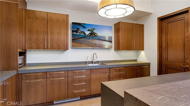 2 Thomas Rd, Ladera Ranch, CA 92694 - kitchen featuring brown cabinetry and dark countertops