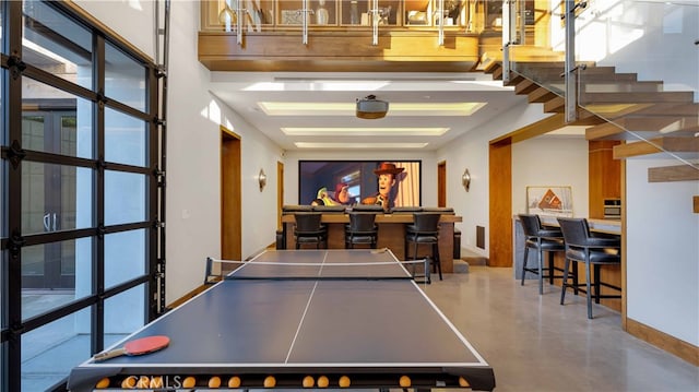 game room with baseboards and finished concrete flooring