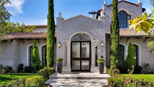 view of exterior entry with a lawn