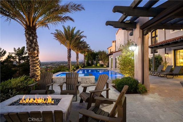 pool at dusk with a pergola, a patio area, and an outdoor fire pit