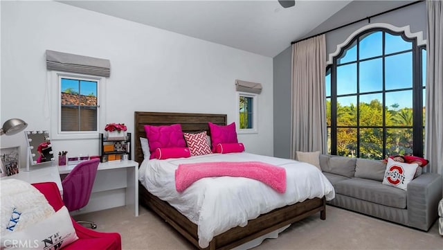 bedroom featuring vaulted ceiling, light carpet, and ceiling fan