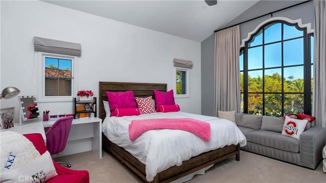 bedroom featuring vaulted ceiling, carpet floors, and multiple windows