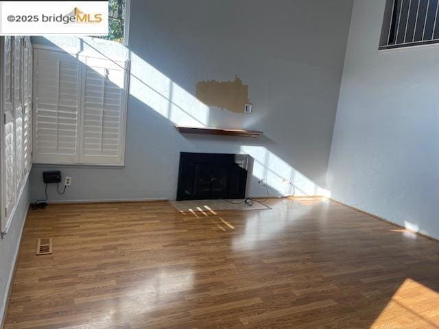 unfurnished living room with hardwood / wood-style flooring