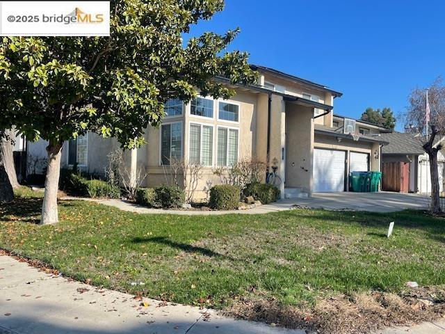 view of front facade with a front lawn and a garage