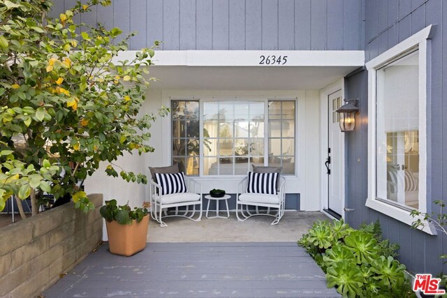 doorway to property with a wooden deck