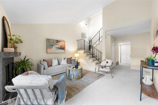 living room featuring carpet, a high end fireplace, and lofted ceiling