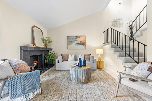 living room with a fireplace and vaulted ceiling