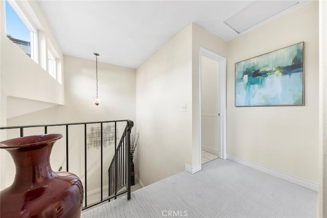 hallway with light colored carpet