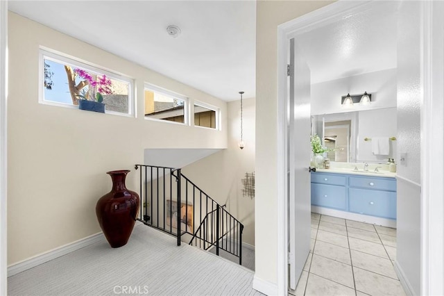 stairway with sink and tile patterned flooring