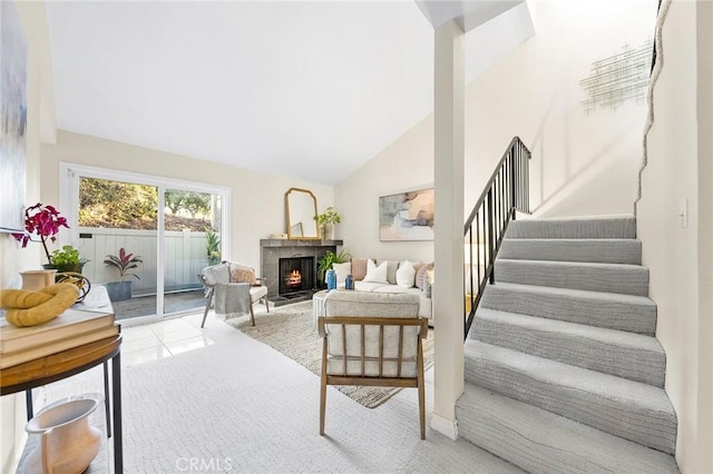 tiled living room with vaulted ceiling and a fireplace