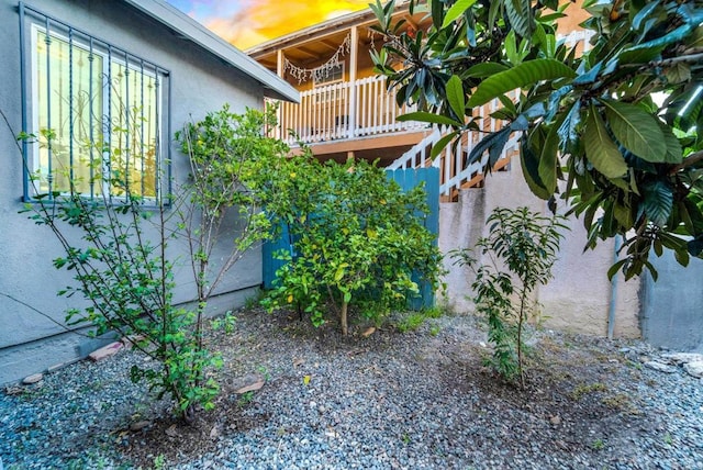 property exterior at dusk with a balcony