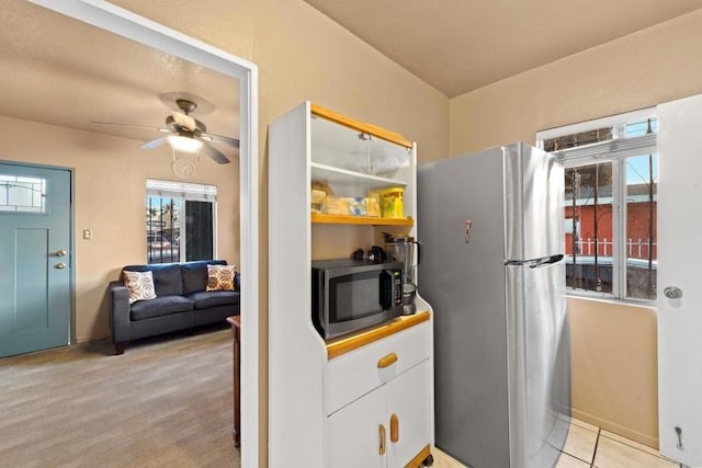 kitchen with white cabinetry, appliances with stainless steel finishes, a healthy amount of sunlight, and ceiling fan