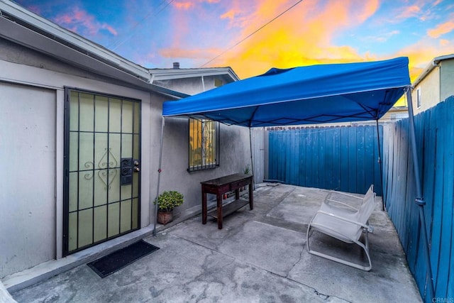 view of patio terrace at dusk