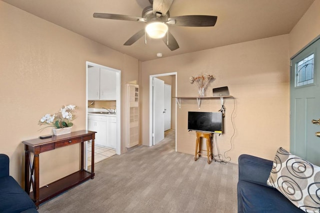 living room with ceiling fan, sink, and light carpet