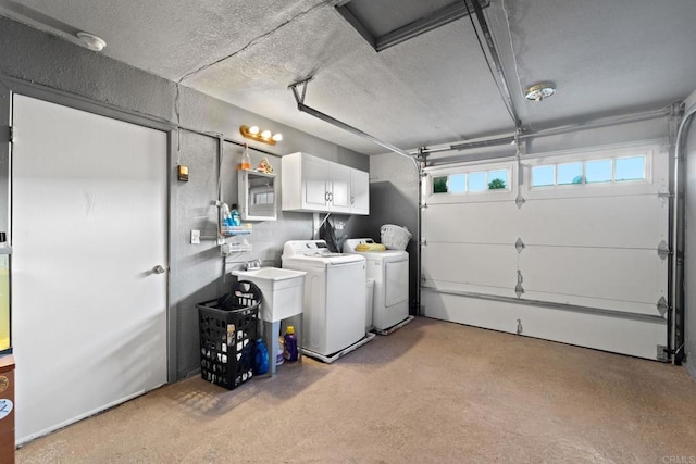 garage featuring sink and washer and clothes dryer