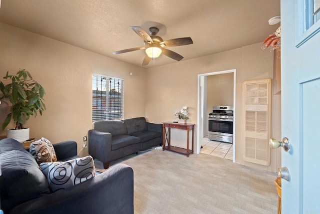 carpeted living room with ceiling fan