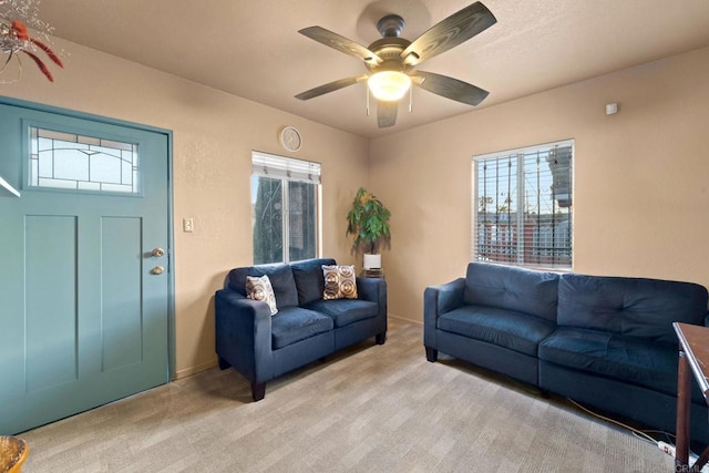 carpeted living room with ceiling fan