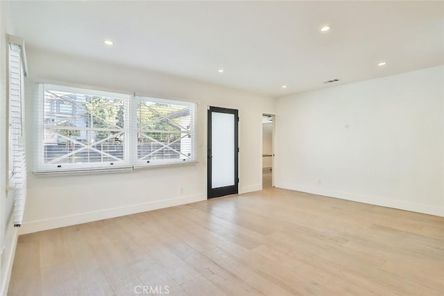 unfurnished room with light hardwood / wood-style flooring