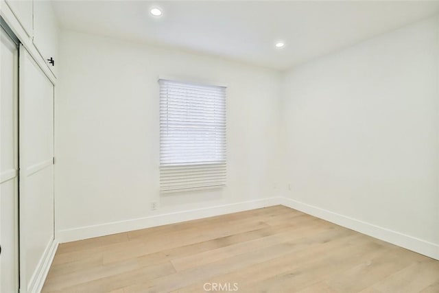 empty room with light hardwood / wood-style flooring