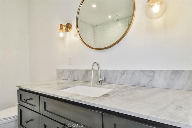 bathroom with toilet and vanity