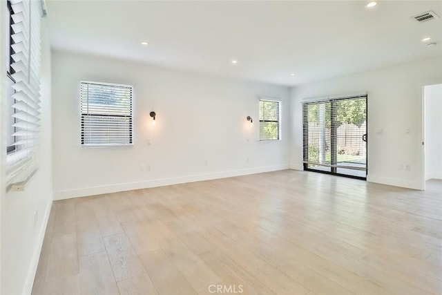 spare room with light hardwood / wood-style floors