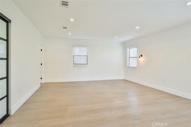 spare room with light hardwood / wood-style flooring