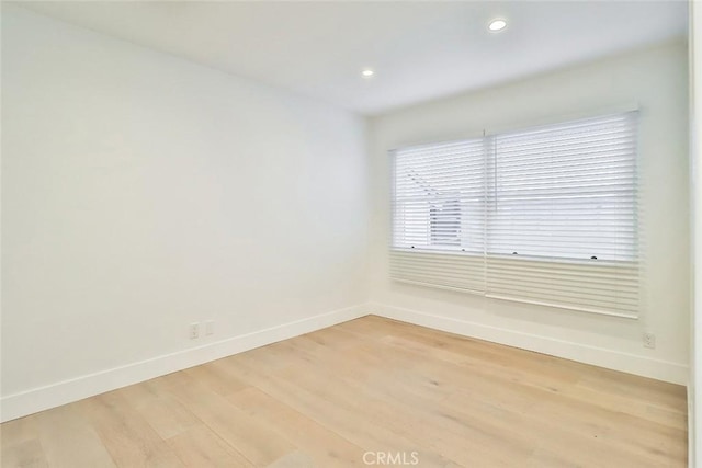 empty room with light hardwood / wood-style floors