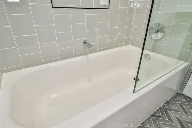 bathroom with tile patterned floors and tiled shower / bath