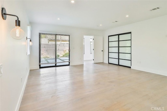 spare room featuring light hardwood / wood-style flooring