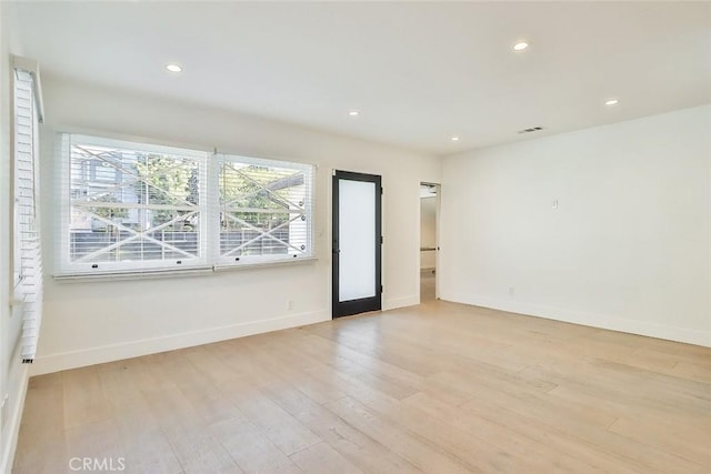 spare room featuring light hardwood / wood-style floors