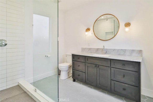 bathroom with toilet, a shower, tile patterned flooring, and vanity