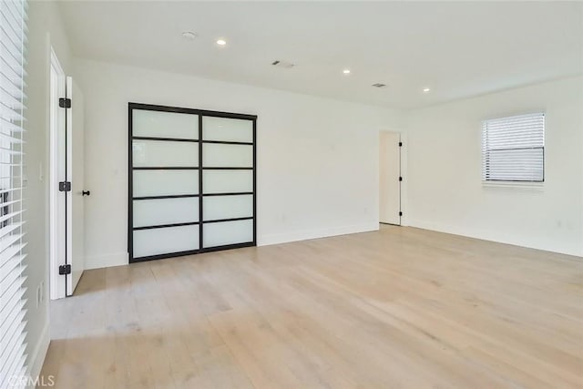 spare room with light wood-type flooring