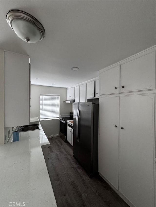 kitchen featuring electric range, sink, stainless steel refrigerator, white cabinets, and dark hardwood / wood-style flooring