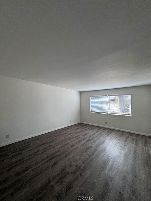 spare room with dark hardwood / wood-style floors