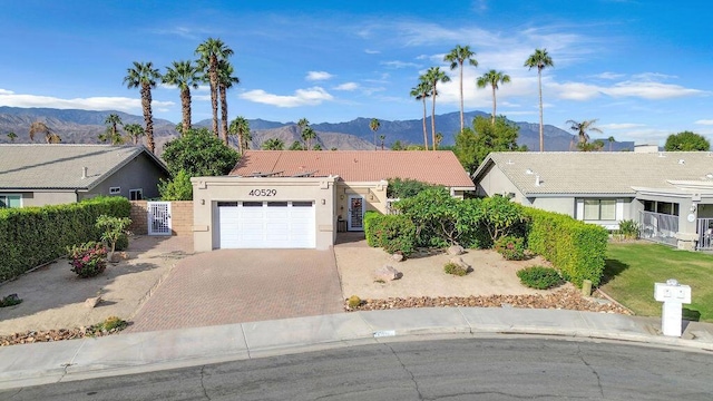 ranch-style home with a mountain view and a garage