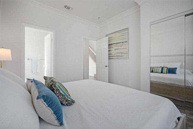 bedroom featuring a closet and crown molding