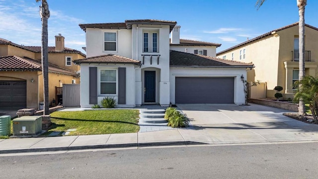 mediterranean / spanish-style home with a garage