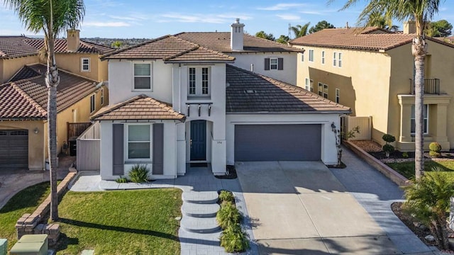 view of front of property with a garage and a front yard