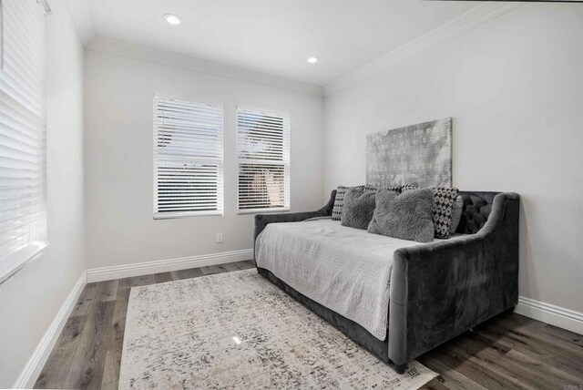 bedroom with dark hardwood / wood-style floors and crown molding