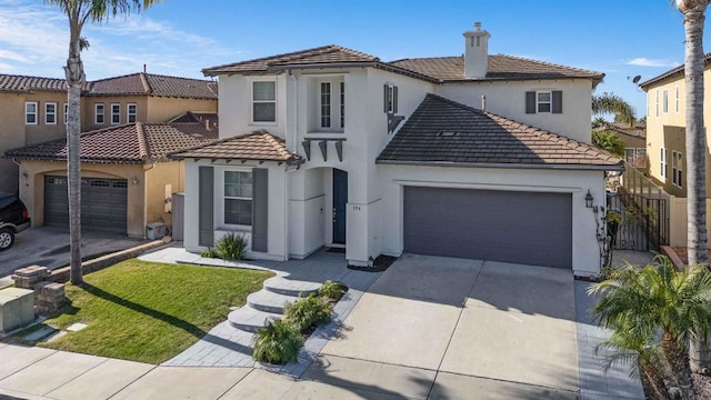 mediterranean / spanish-style house with a front lawn and a garage