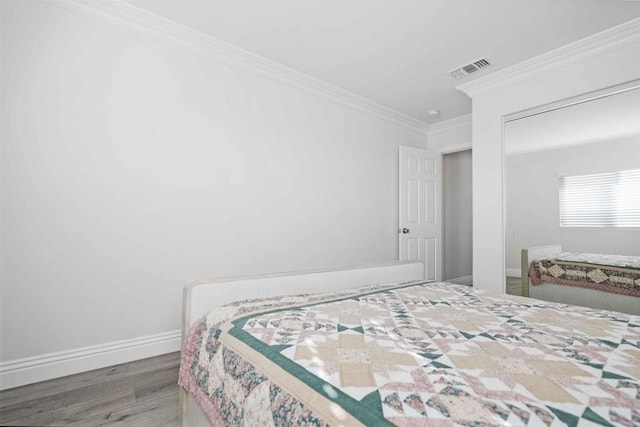 bedroom featuring crown molding and hardwood / wood-style floors