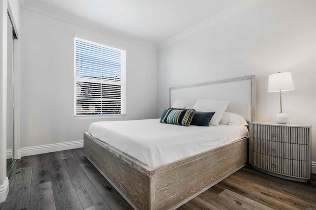 bedroom with dark hardwood / wood-style flooring and ornamental molding